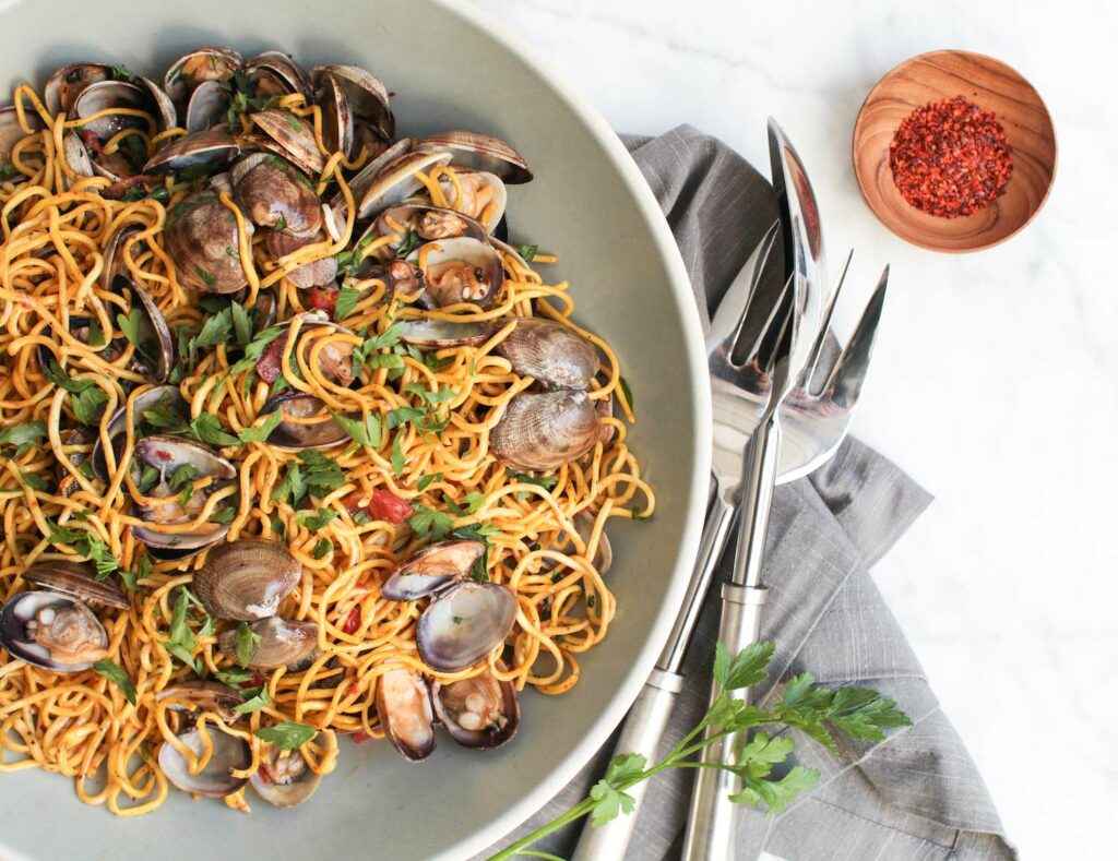 Linguine with Manila Clams and Tomatoes plated with cutlery