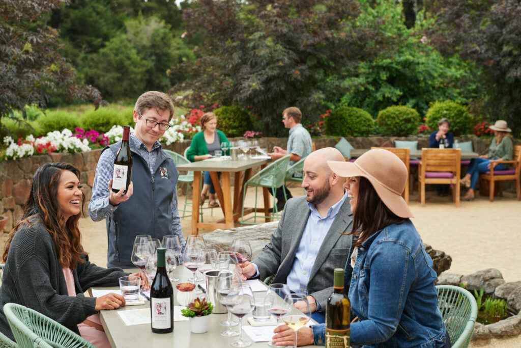 group sitting outside enjoying wine